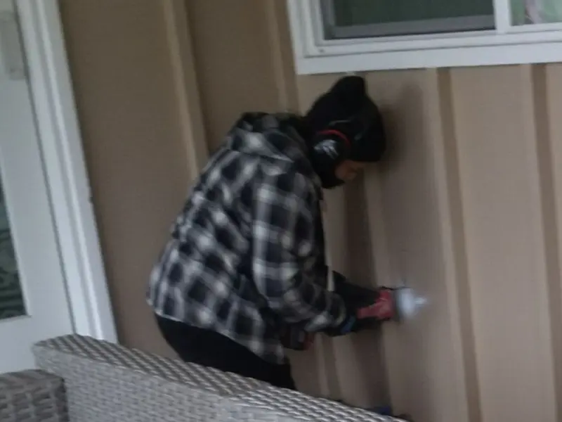 Professional electrician installing an exterior outlet in Needles